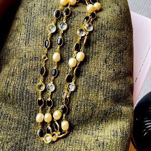 Channel like necklace with pear, crystal and black faceted stone